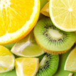 Close-up of fresh sliced citrus and kiwi fruits showcasing vibrant colors and textures.